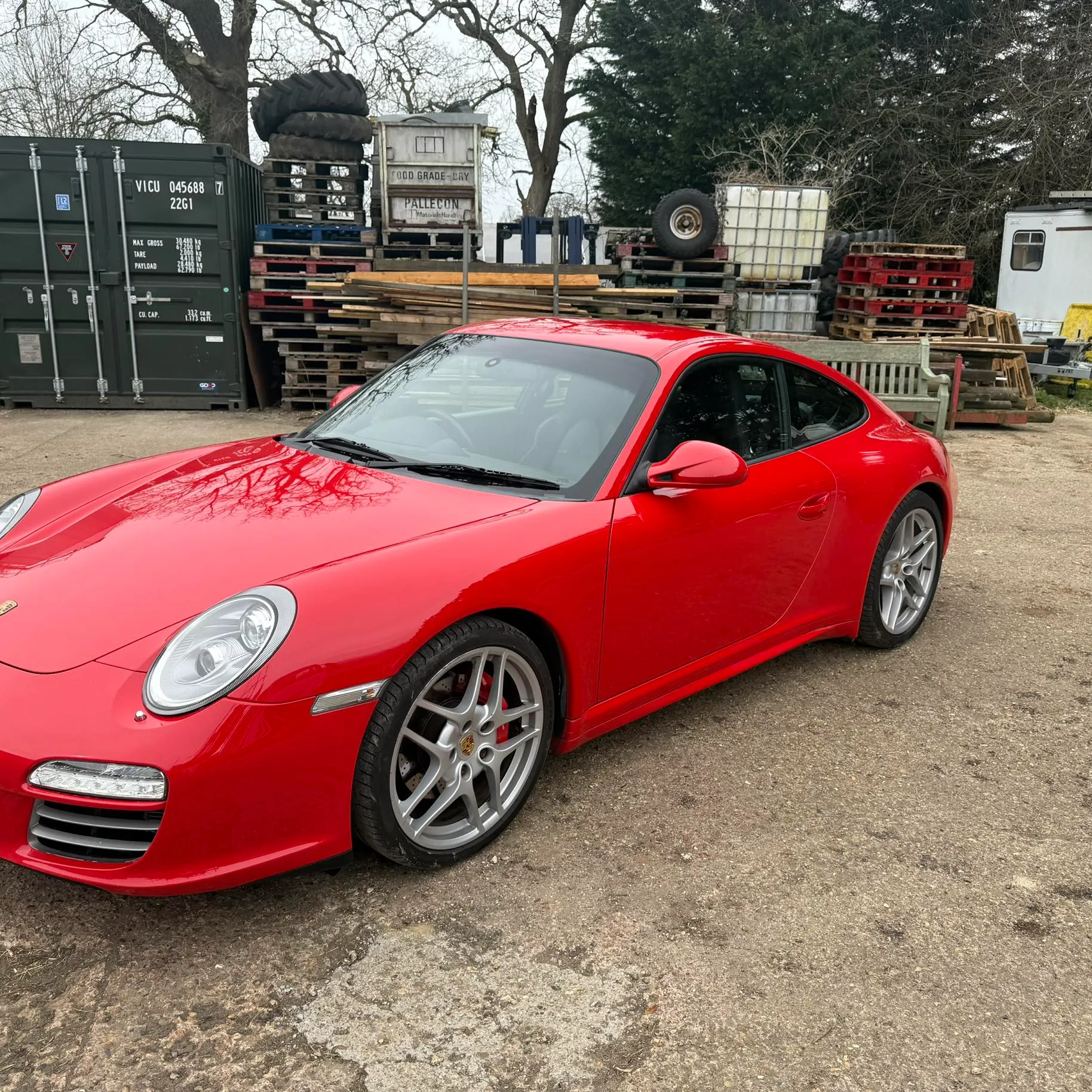 A red sports car parked in a parking lot.