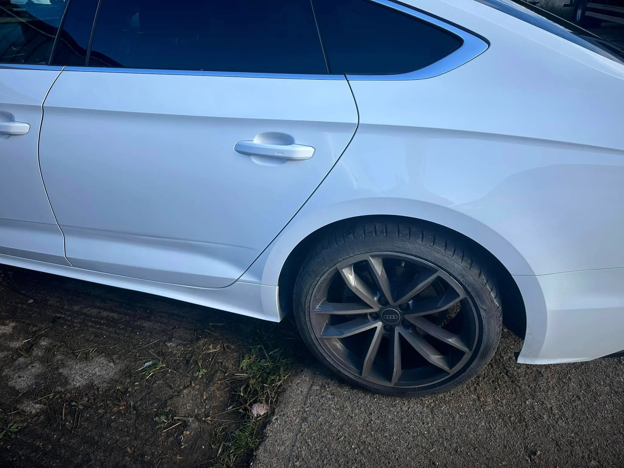 A white car parked on the side of the road.