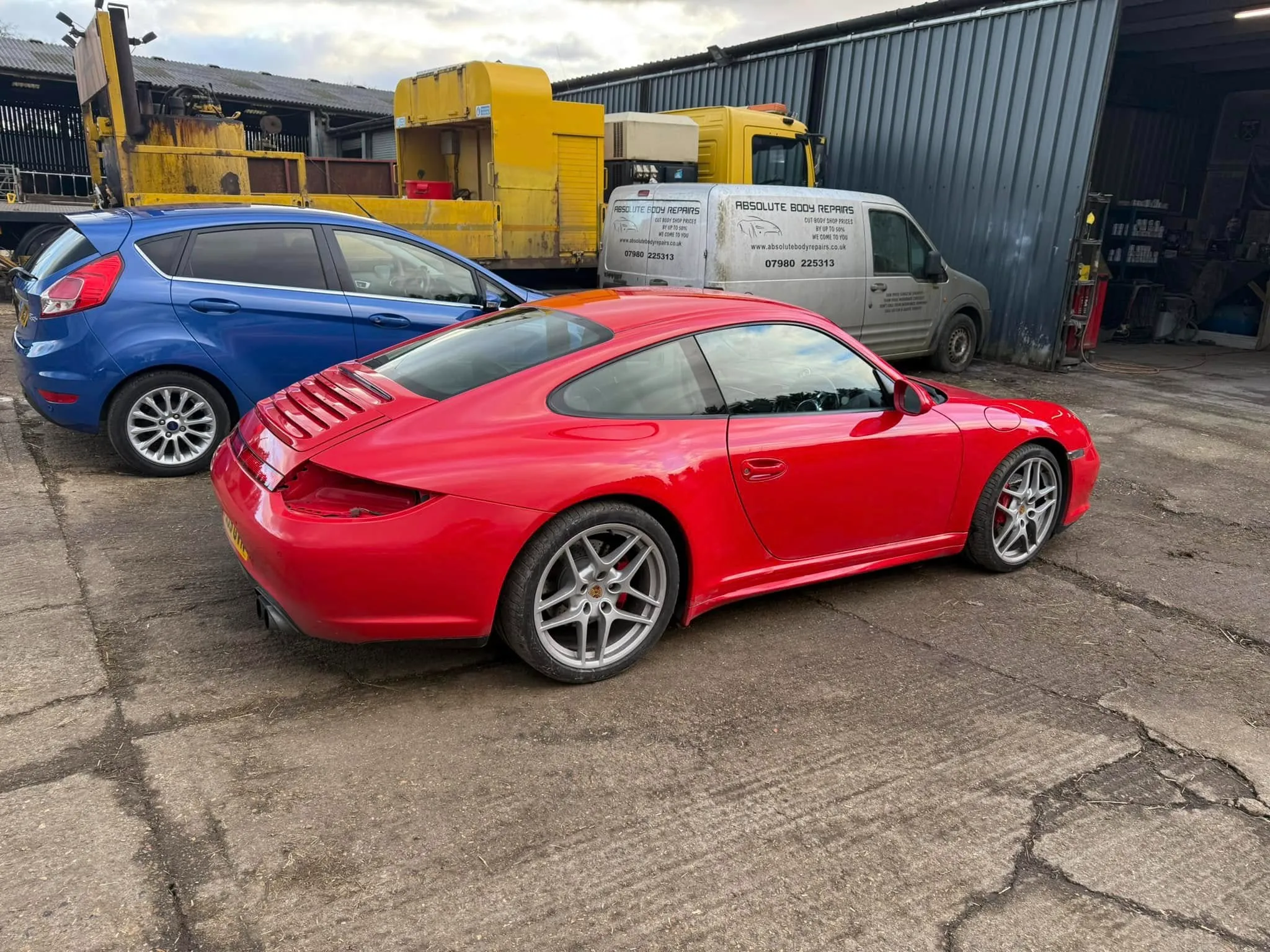 A red sports car parked next to a blue sports car.